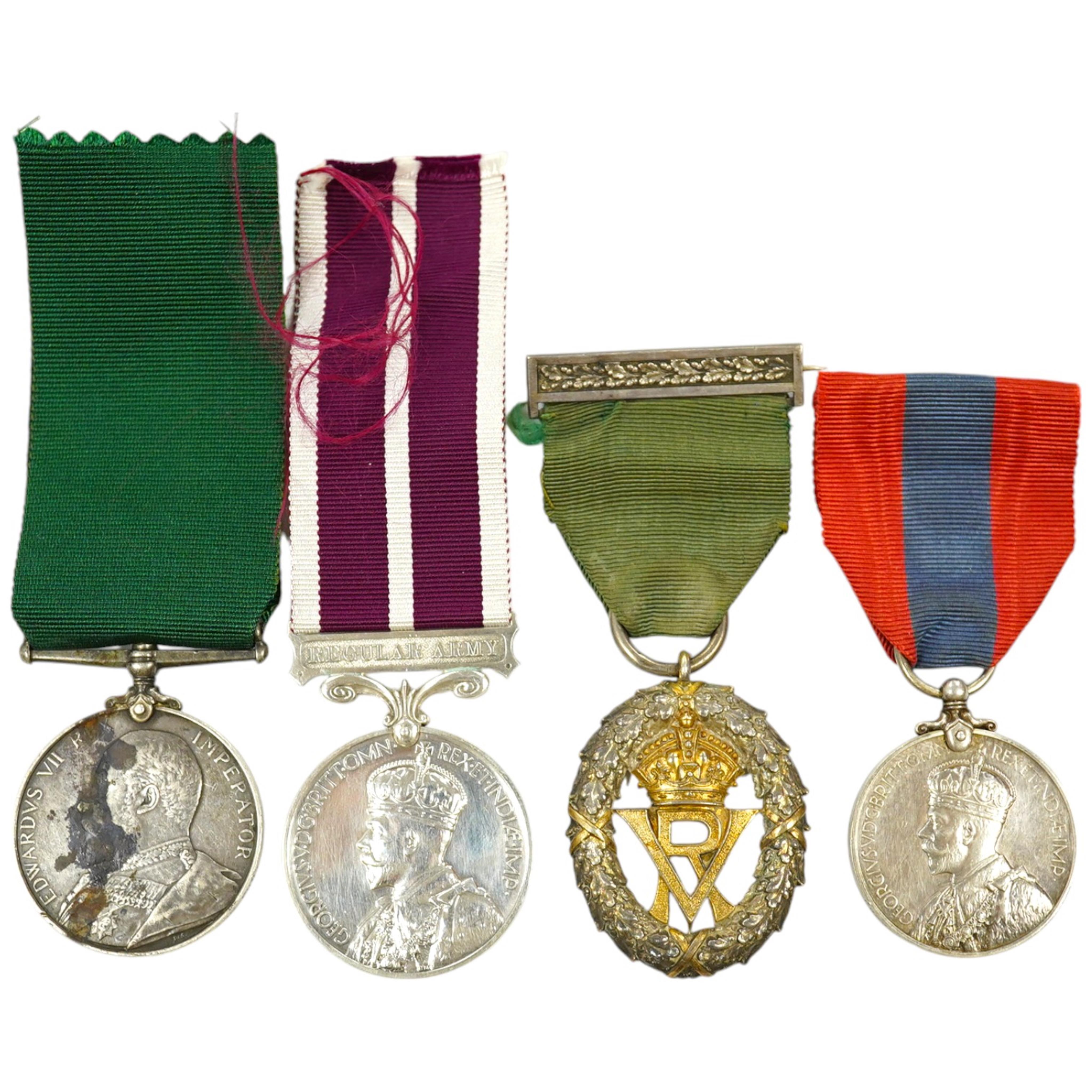 Four assorted service medals; Volunteer Officer's Decoration, hallmarked for 1892; EdVII Volunteer Long Service Medal to 3648 Pte W.Austin I/V B:Lanc:Fus; GV Imperial Service Medal to Frederick Allan Heselwood & Gv Regul